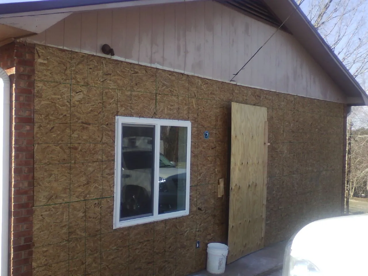 OSB sheathing on a garage addition wall before siding in Richmond