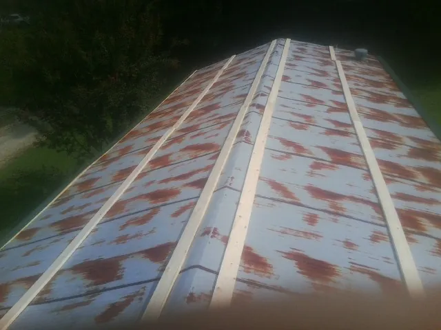 Rusted metal roof panels with new wood purlins before replacement — Storm Damage Roof Repair in Richmond by Roofing Brothers